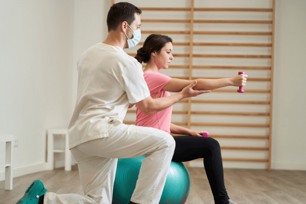 Physical Therapist helping a patient stretch